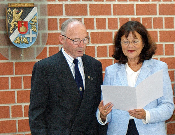 Landrätin Theresia Riedmaier verliest die Urkunde des Landes Rheinland-Pfalz: Landesehrennadel für Rolf Beppler. Foto: kv-süw