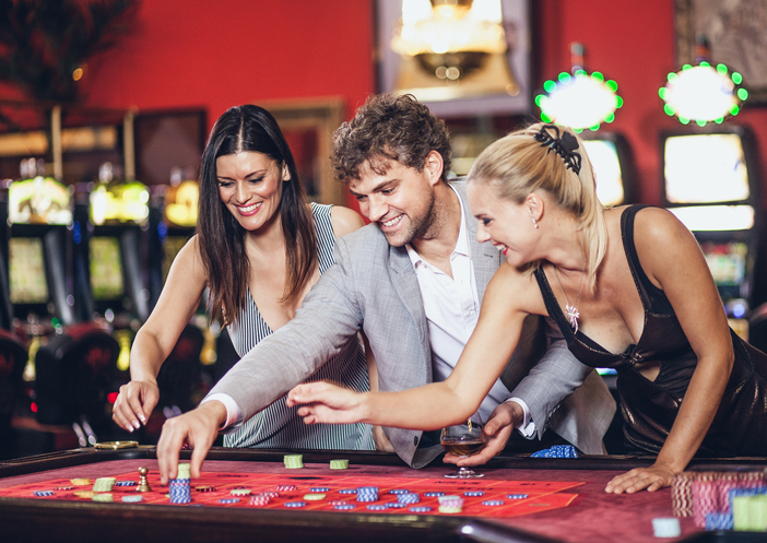 Young people playing roulette at the casino