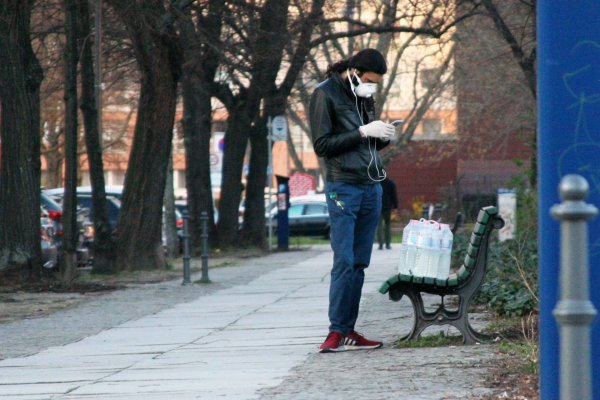 Mann mit Wasserflaschen und Mundschutz